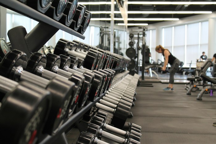 A gym with dumbbells and strength-training equipment